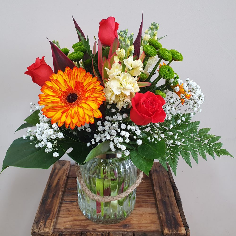 Bouquet of bright coloured flowers in a stylish glass vase for delivery in Rockingham