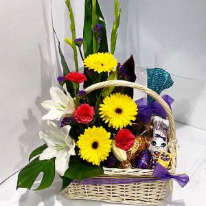 Easter basket with Flowers, Easter Eggs and Hot Cross Buns