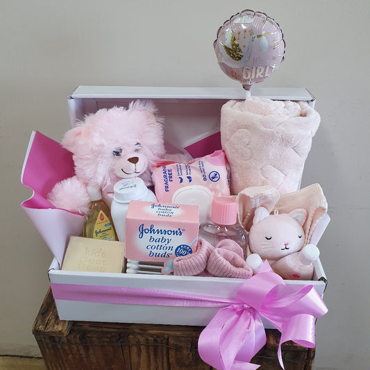 A baby shower gift basket arranged in a white box with pink ribbon, featuring a pink teddy bear, pink plush toy, baby wipes, Johnson's baby wipes, a bottle of baby lotion, a pink blanket, and a pink foil balloon or delivery to Rockingham Hospital, Peel Health Campus, Kwinana, Baldivis