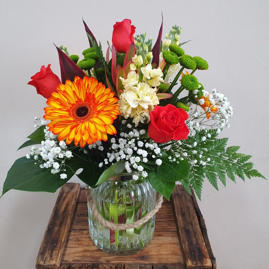 Bouquet of bright coloured flowers in a stylish glass vase for delivery in Rockingham