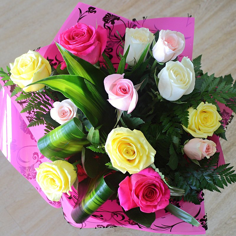 A beautiful bouquet of a dozen mixed-colour long-stem roses hand-wrapped by Hanging Basket Florist Rockingham
